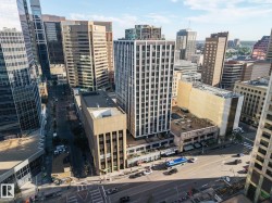 Urban landscape featuring diverse architectural styles, multi-lane roadways, and commercial buildings - 