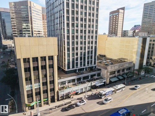 Urban streetscape with commercial buildings, a multi-story high-rise, and a busy thoroughfare - #1313 10024 Jasper Av Nw, Edmonton, AB 