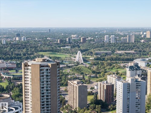 Expansive urban landscape featuring multiple high-rise buildings, extensive green spaces, and a distinctive white arch bridge - #1313 10024 Jasper Av Nw, Edmonton, AB 