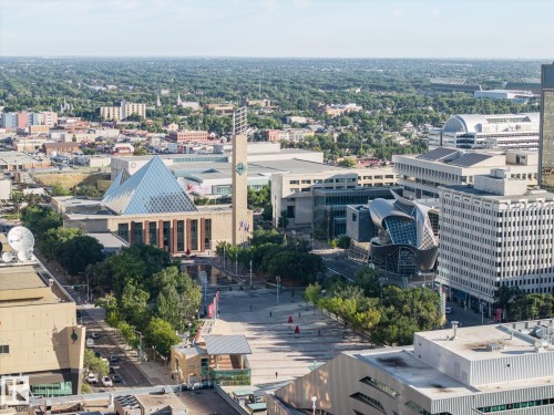 Expansive cityscape featuring diverse architectural styles, visible urban green spaces, and prominent civic buildings - #1313 10024 Jasper Av Nw, Edmonton, AB 