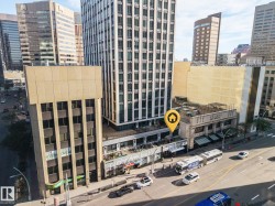 Urban setting featuring multiple high-rise buildings and street-level commercial establishments - 