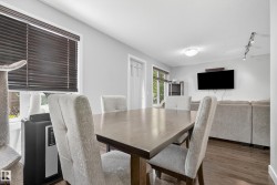 Wood-finish flooring throughout, light gray wall color, and track lighting - 