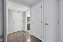Wood-finish flooring, recessed ceiling lighting, and solid core doors with brushed nickel hardware - #107 1031 173 St Sw, Edmonton, AB 
