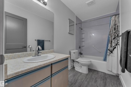Vanity with integrated sink, chrome faucet, and under-counter storage - 442 Kirkpatrick Crescent Nw, Edmonton, AB 