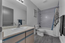 Vanity with integrated sink, chrome faucet, and under-counter storage - 