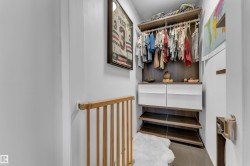 Custom closet system with wood-finish shelving, built-in drawers, and hanging rods - 