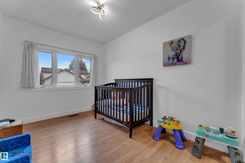 Hardwood-finish flooring, white walls, and a multi-pane window - 442 Kirkpatrick Crescent Nw, Edmonton, AB 