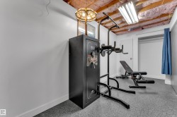 Recessed lighting, painted walls, and an open ceiling with visible insulation - 