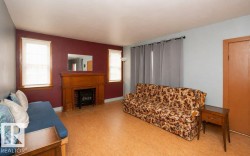 Living area featuring a prominent wood fireplace surround with a brick firebox - 