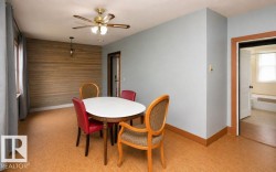 Room featuring a wood-panel accent wall, light blue painted walls, and wood-finish flooring - 