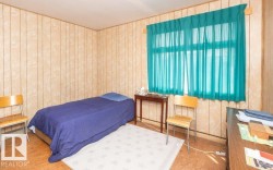Bedroom featuring paneled walls and wood-finish flooring - 