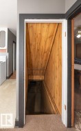 Wood-paneled stairwell entry with dark trim - 