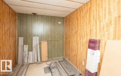 Interior space featuring wood-look paneling on walls and a light-colored ceiling - 