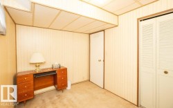 Room featuring vertical paneling, acoustic ceiling tiles, and carpet flooring - 