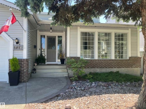 Gray siding exterior with brick accents and a prominent front entrance - 716 Hendra Crescent Nw, Edmonton, AB - Outdoor With Facade
