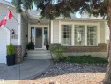 Gray siding exterior with brick accents and a prominent front entrance - 716 Hendra Crescent Nw, Edmonton, AB  - Outdoor With Facade 