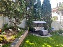 Expansive backyard featuring a lush lawn, mature trees, and a privacy fence - 716 Hendra Crescent Nw, Edmonton, AB  - Outdoor With Backyard 