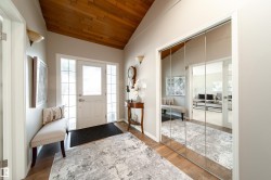 Spacious room featuring neutral carpeting, crown molding, light gray wall paint, and French doors - 