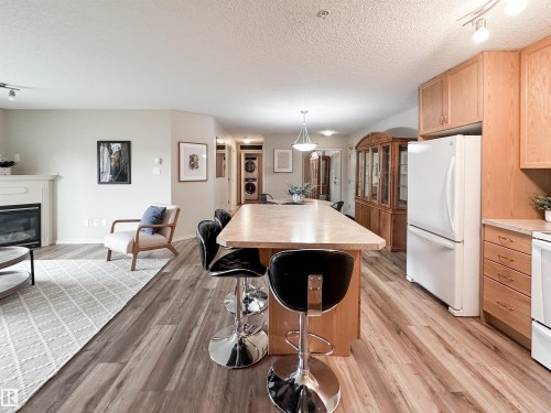 #140 78B Mckenney Av, St. Albert, AB - Indoor Photo Showing Kitchen With Fireplace