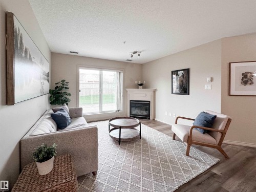 #140 78B Mckenney Av, St. Albert, AB - Indoor Photo Showing Living Room With Fireplace