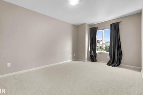 Neutral wall paint with window, light-colored carpeting, and ceiling-mounted light fixture - #5 5120 164 Av Nw, Edmonton, AB 