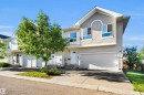 Light-toned siding exterior with a prominent two-car garage - #5 5120 164 Av Nw, Edmonton, AB 
