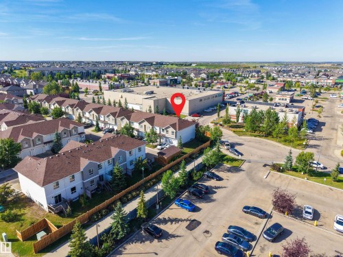 Residential community with surrounding commercial structures, surface parking, and mature trees - #5 5120 164 Av Nw, Edmonton, AB 