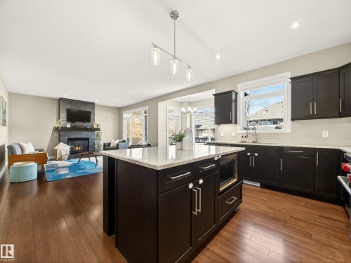 5610 Pierre Court, Beaumont, AB - Indoor Photo Showing Kitchen With Fireplace With Upgraded Kitchen