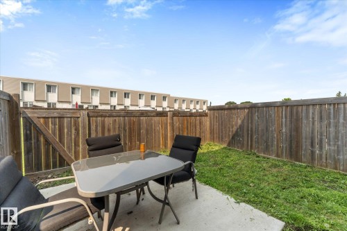 Private outdoor patio with a concrete slab, bordered by a wooden fence, and featuring a grass area - 173 Cornell Court Nw, Edmonton, AB - Outdoor
