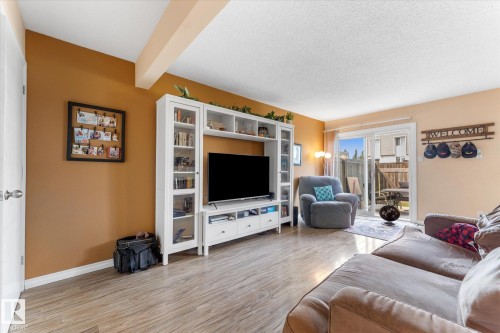 Spacious room with wood-finish flooring, a neutral ceiling, and two-tone wall finishes - 173 Cornell Court Nw, Edmonton, AB - Indoor Photo Showing Living Room