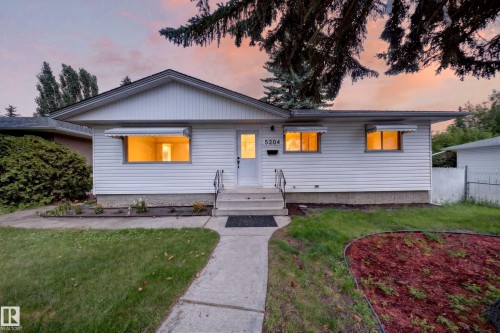 White siding exterior with a pitched roofline, concrete walkway, and a tiered concrete entry - 5204 97A Avenue Nw, Edmonton, AB 
