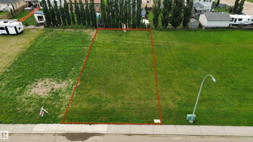 Grassed residential building lot with mature trees at the rear boundary - 20 Monterey Estates, Wetaskiwin, AB 