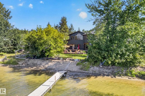 Waterfront property featuring a private dock, boat launch, and mature trees - 51 Itaska Beach, Rural Leduc County, AB 