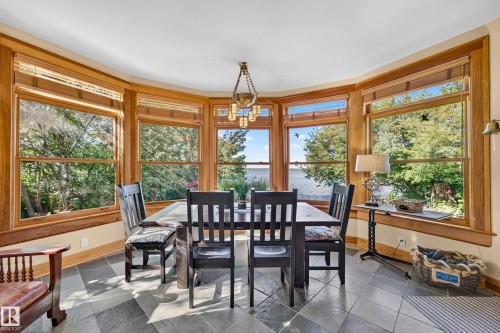 Bay window with wood trim, slate tile flooring, pendant light fixture, and water scenery - 51 Itaska Beach, Rural Leduc County, AB 