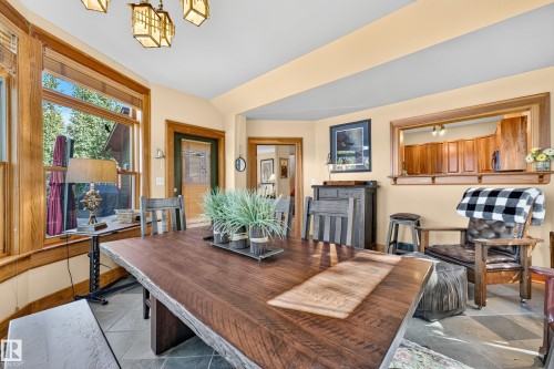 Vaulted ceiling with decorative lighting, wood-trimmed windows, slate-style flooring, and wood interior doors - 51 Itaska Beach, Rural Leduc County, AB 