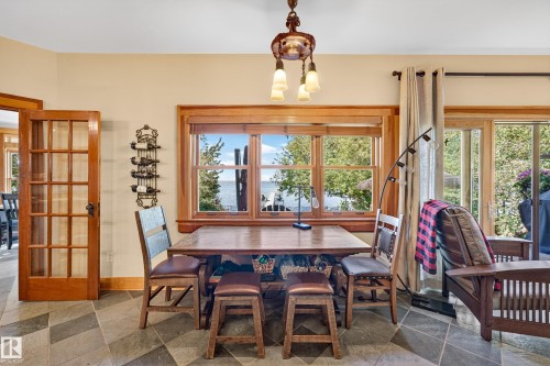Slated tile flooring throughout, wood-framed windows, and a glass-paneled interior door - 51 Itaska Beach, Rural Leduc County, AB 