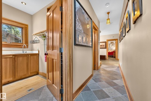 Entryway featuring natural wood trim, mixed-tone tile flooring, and recessed lighting - 51 Itaska Beach, Rural Leduc County, AB 