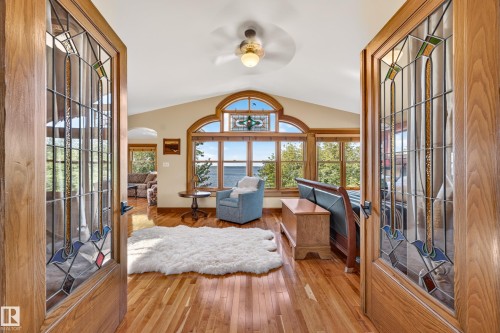 Hardwood flooring, vaulted ceiling, arched windows, transom window, and a ceiling fan - 51 Itaska Beach, Rural Leduc County, AB 