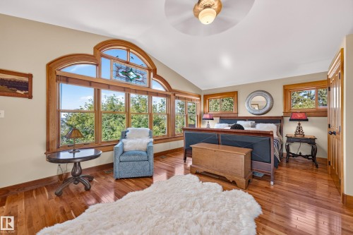 Vaulted ceiling, wood-finish flooring, custom arched window, stained glass accent, natural wood trim - 51 Itaska Beach, Rural Leduc County, AB 