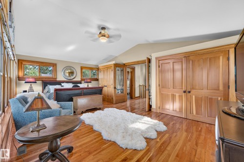 Hardwood flooring, recessed lighting, ceiling fan, natural wood trim, and multiple windows with outdoor views - 51 Itaska Beach, Rural Leduc County, AB 