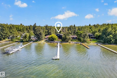 Waterfront property featuring multiple docks and a boat lift - 51 Itaska Beach, Rural Leduc County, AB 