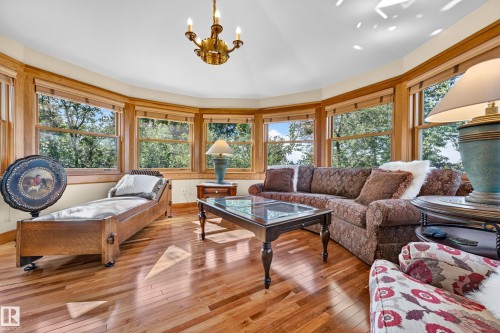 Hardwood flooring, bay windows with wood trim, ceiling-mounted chandelier, and recessed lighting - 51 Itaska Beach, Rural Leduc County, AB 