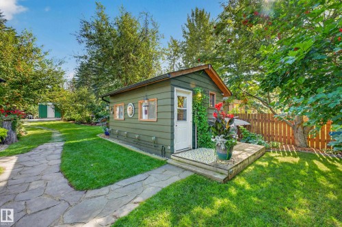 Wood-sided outbuilding with multiple windows, leading to a small wooden deck - 51 Itaska Beach, Rural Leduc County, AB 
