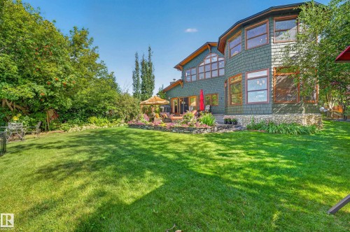 Expansive green lawn with mature perimeter trees - 51 Itaska Beach, Rural Leduc County, AB 