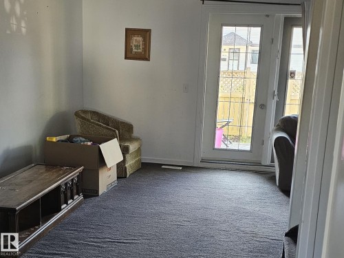 Wall-to-wall carpeting, light-colored walls, and a glass-paneled exterior door - 14674 54 Street Northwest, Edmonton, AB 