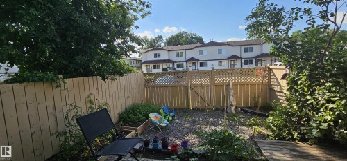 Enclosed backyard featuring wood fencing and mature perimeter trees - 14674 54 Street Northwest, Edmonton, AB 
