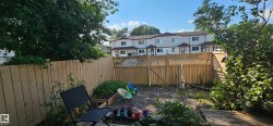 Enclosed backyard featuring wood fencing and mature perimeter trees - 