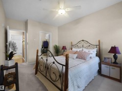 Vaulted ceiling, ceiling fan, carpet flooring, open closet, and open doorway - 