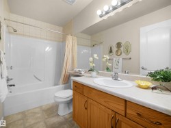 White integrated tub and shower combination with tiled surround - 