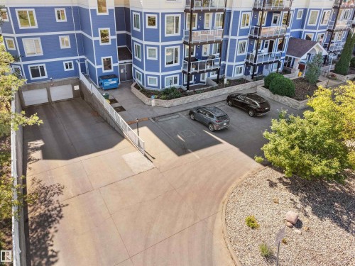Multi-story building with blue siding and white trim - #206 12111 51 Av Nw, Edmonton, AB 
